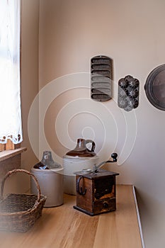 Old fashioned kitchen counter with jugs and grinder