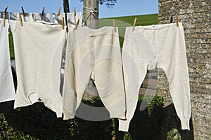 Old-fashioned knitted long woolen underwear on a line