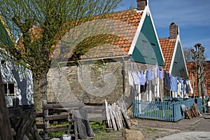 Old-fashioned laundry drying in wind on clotheslines. Walking in historical Dutch fisherman`s village in North-Holland, Enkhuizen