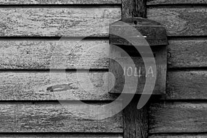 Old-fashioned mailboxes on wooden wall