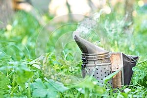 Old fashioned metal bee smoker at the apiary