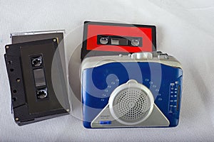Old-fashioned music cassette and walkman isolated on white ackground