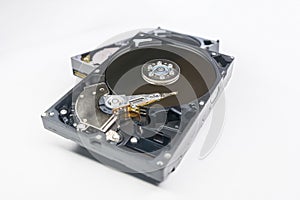 Old fashioned, open, mechanical harddisc drive, isolated on a white background