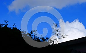 The old-fashioned outdoor antenna against blue sky