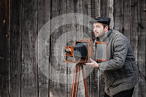 Old fashioned photographer works with large format camera. Concept - photography of the 1930s-1950s