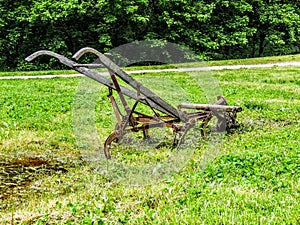 Old fashioned plough in a field photo