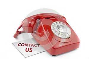 Old fashioned red telephone with contact us messag