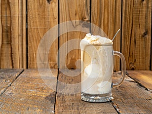 Old Fashioned Root Beer ice cream float on a rustic wooden background with copy space.