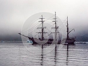 An old-fashioned Schooner style-ship anchored in Port Lockroy, Antarctica