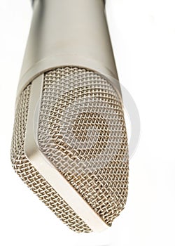 An old fashioned microphone in front of a white background