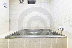 Old-fashioned stainless steel bathtub in the bathroom