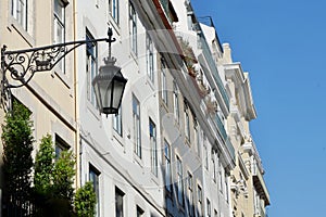 Old fashioned street lamp against traditional facades in Lisbon, Portugal. Portuguese architecture