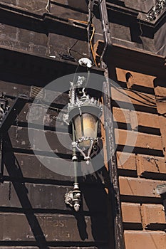 Old fashioned street lamp. Decorative lamps on building in the street