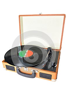 An old-fashioned suitcase record player and turntable with a vinyl record, isolated on white background
