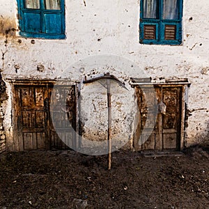 Old fashioned traditional dirty wood windows and doors in small mountain village in Nepal