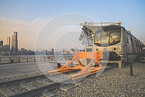 Old fashioned train terminated at buffer stop, urban backdrop Jan 12 2024