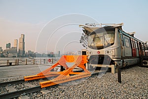 Old fashioned train terminated at buffer stop, urban backdrop Jan 12 2024