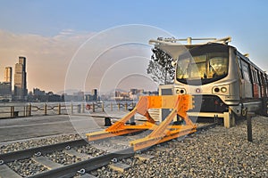 Old fashioned train terminated at buffer stop, urban backdrop Jan 12 2024