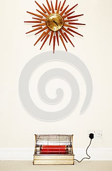 Old fashioned wall clock and heater