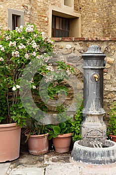 Old fashioned water fountain in the Tuscan hillside town of Barberino Val D`Elsa.