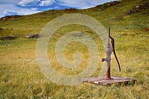 Old fashioned water pump out in a Field