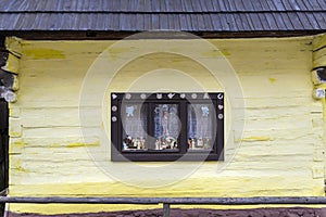 Old-fashioned window of wooden house in Vlkolinec