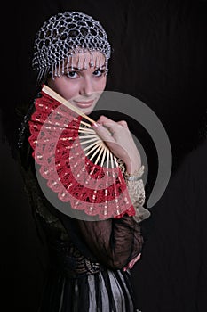 Old fashioned woman with fan