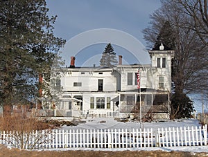 Old fashoined home with white picket fence