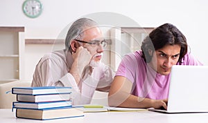 Old father helping his son in exam preparation