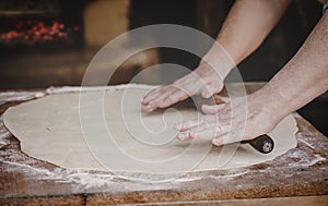 Old female hands kneading dough