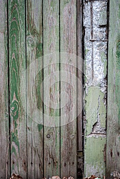 Old fence made of wooden planks, in the style of rustic, grunge, worn gray-green color with nails