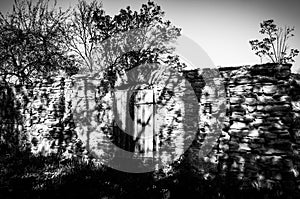 Old fence of the rocks with black shadows