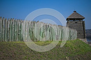 old fence of a stockade and watchtower against a blue sky background