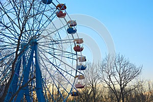 Old Ferris wheel at an amusement Park at sunset.