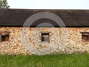 Old fieldstone and timber one story structure in NYS FingerLakes region photo