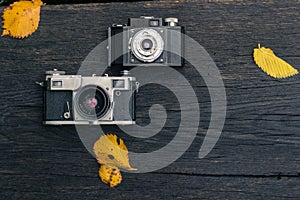 Old film camera on grunge dark wooden background