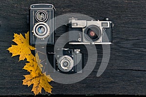 Old film camera on grunge dark wooden background