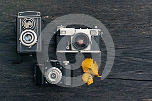 Old film camera on grunge dark wooden background