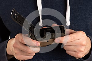 Old film camera in hands of man