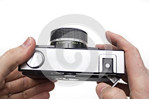 Old film camera in hands