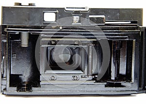 Old film camera. Rarity camera on a white background. A camera in muse hands, cocking. Soviet photographic equipment. The camera