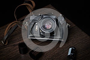 Old film camera in a time-worn case, top view