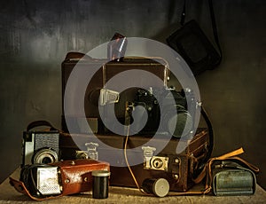 Old film cameras, photographic film, leather cases for photographic equipment. Old photographic equipment.