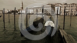 Old film effect footage of the Venetian gondolas rocking on the waves in front of Piazza San Marco