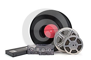 Old film reel with strip , photographic film, audio recordings and vinyl records