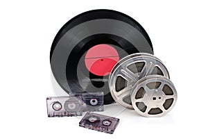 Old film reel with strip , photographic film, audio recordings and vinyl records