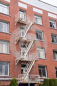 An old fire escape stairs on the side of a building.