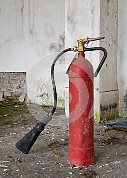 Old fire extinguisher in abandoned building