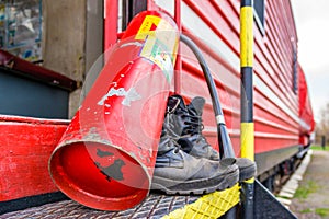 Old firefighter boots on the background of red fire train