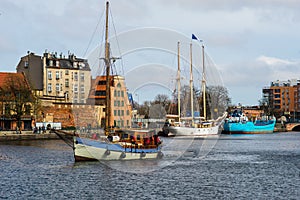 Old fishboat entering Gdansk harbor in Poland